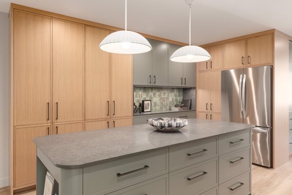 Kitchen island with pendant lights and wood cabinetry