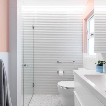 Modern bathroom with white vanity, glass shower, and minimalist West Coast design completed under Pickard Construction as the general contractor in the Parksville–Qualicum Beach area.